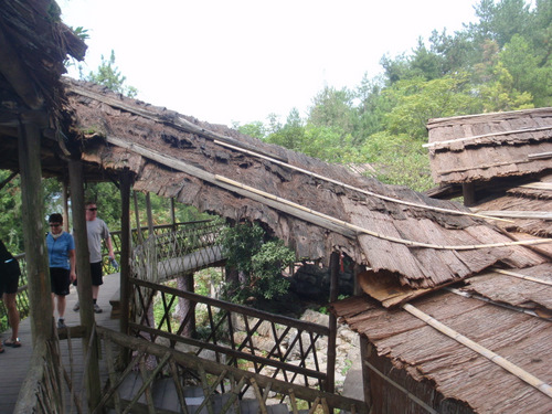 Walkways demonstrate bark shingle roof style.